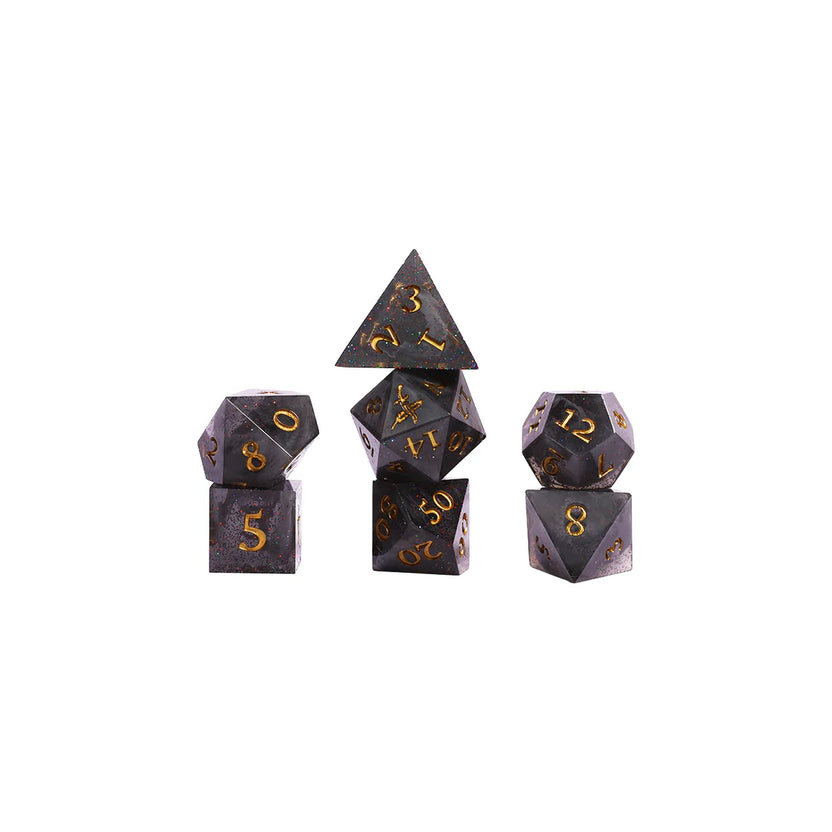Set of polyhedral dice stacked full set black graphite and gold shimmer with gold numbering