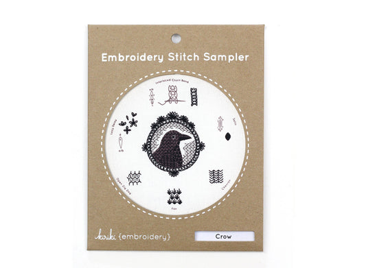 crow embroidery stitch sampler, Kiriki Press embroidery kit, beginner embroidery sampler, how to embroider sampler kit, blackwork stitches, DMC floss kit, embroidery hoop art, stitched crow pattern, learn embroidery stitches, DIY embroidery gift
