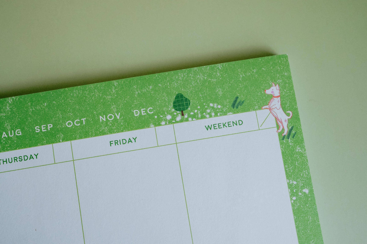 Detail of illustrated dogs along the edge of the Dog Days weekly planner