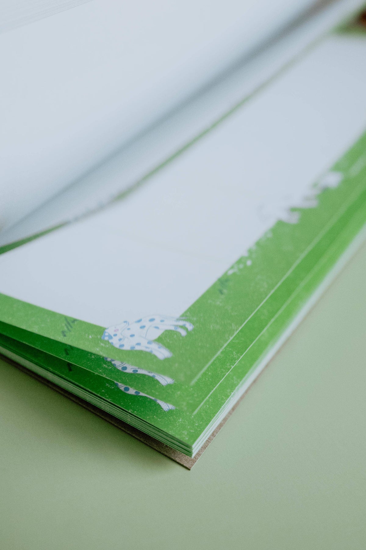 Stack of tear-off pages on the Dog Days weekly planner notepad