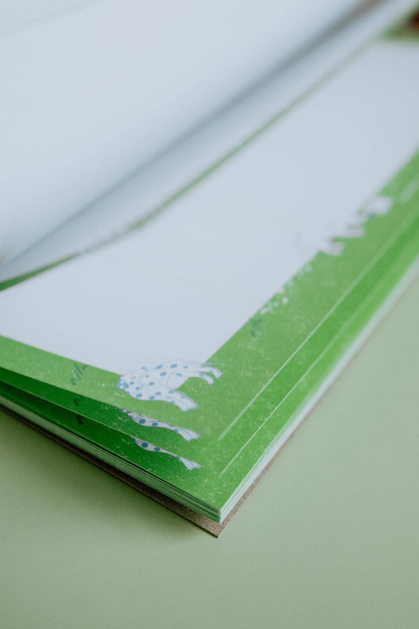 Stack of tear-off pages on the Dog Days weekly planner notepad