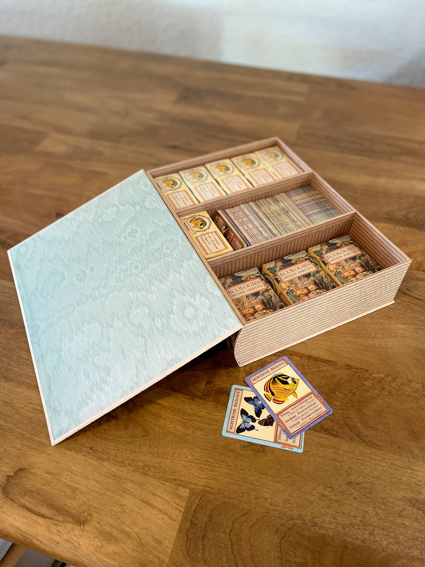 Ecologies card game organizer, faux book box card storage, vintage book game organizer, poker card storage box, ecological card game accessory, tuck box storage container, magnetic closure card holder, deck box for Ecologies games, antique map book box, card game collector case, stylish card deck organizer