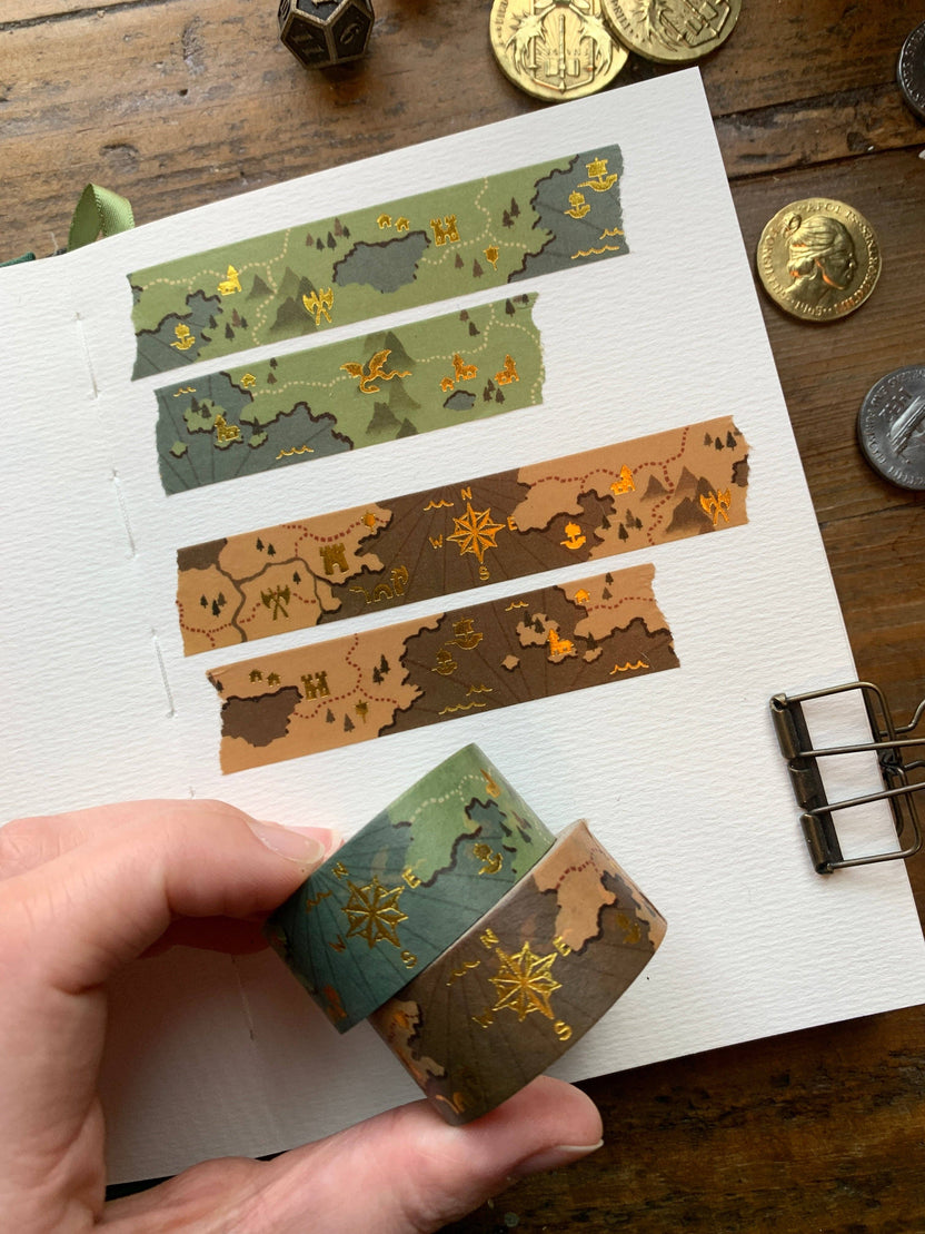 fantasy map washi tape, gold foil washi tape, D&D journal accessories, map design washi, RPG washi tape, character sheet decoration, eco-friendly washi tape, travel journal tape, parchment-style washi, green blue washi tape, brown washi tape, worldbuilding stationery, fantasy-themed washi, scrapbooking tape, biodegradable rice paper tape