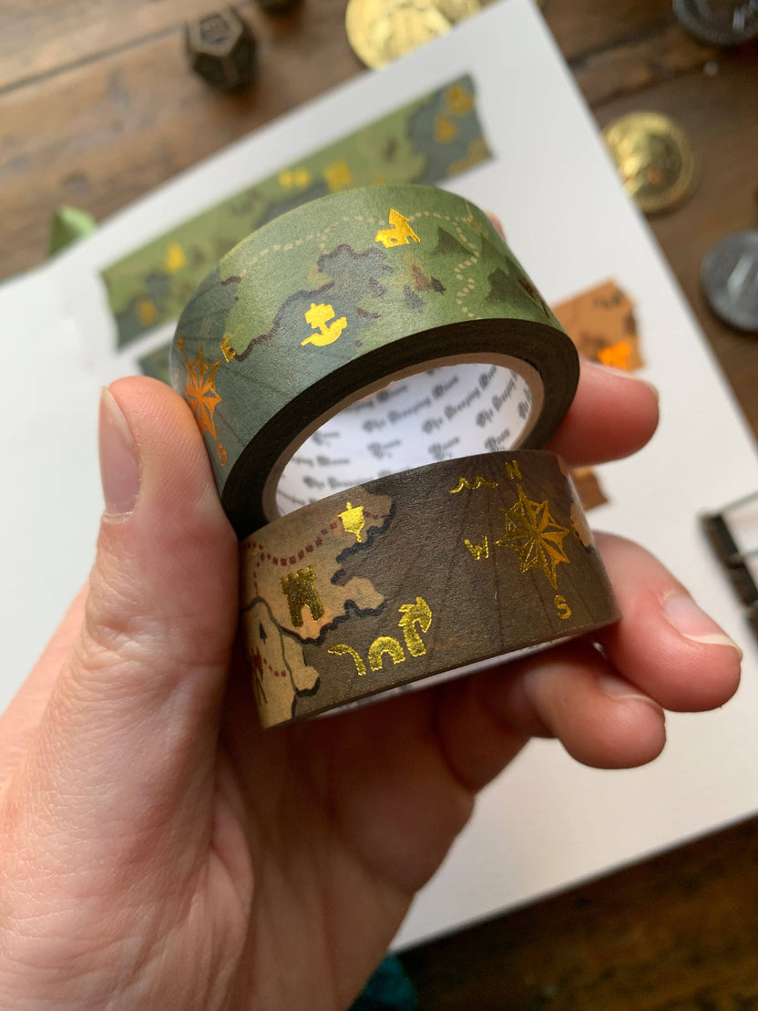 fantasy map washi tape, gold foil washi tape, D&D journal accessories, map design washi, RPG washi tape, character sheet decoration, eco-friendly washi tape, travel journal tape, parchment-style washi, green blue washi tape, brown washi tape, worldbuilding stationery, fantasy-themed washi, scrapbooking tape, biodegradable rice paper tape