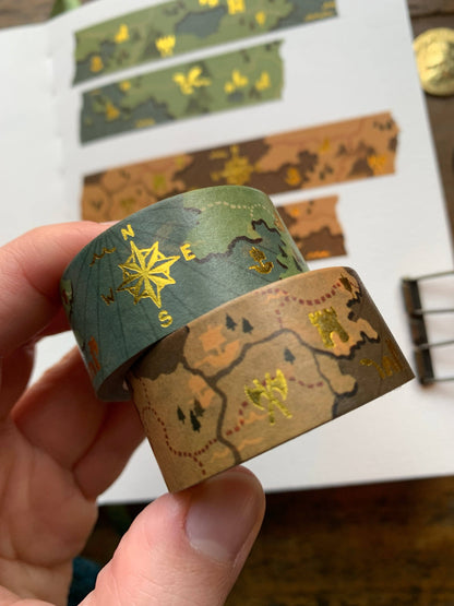 fantasy map washi tape, gold foil washi tape, D&D journal accessories, map design washi, RPG washi tape, character sheet decoration, eco-friendly washi tape, travel journal tape, parchment-style washi, green blue washi tape, brown washi tape, worldbuilding stationery, fantasy-themed washi, scrapbooking tape, biodegradable rice paper tape