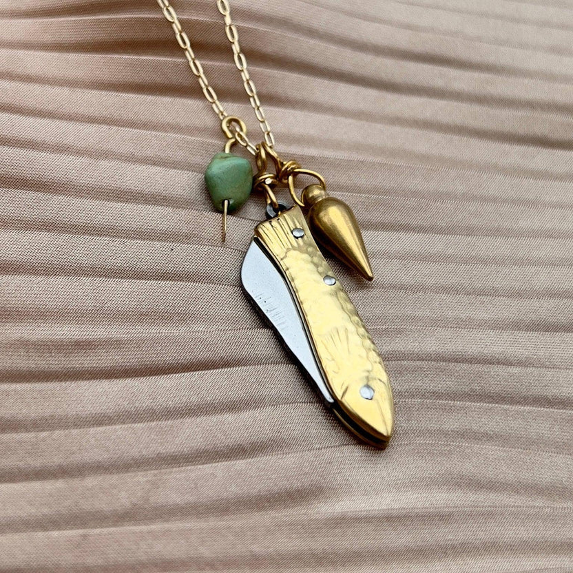 feeesh knife necklace, fish knife pendant, mini knife necklace, pocket knife necklace for women, functional fish knife jewelry, turquoise bullet charm necklace, rogue style necklace, campfire necklace with blade, fishing knife pendant, everyday carry necklace, catch and release jewelry, tiny blade necklace, adventurer pocket knife jewelry, quirky knife necklace, real mini knife pendant