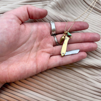 feeesh knife necklace, fish knife pendant, mini knife necklace, pocket knife necklace for women, functional fish knife jewelry, turquoise bullet charm necklace, rogue style necklace, campfire necklace with blade, fishing knife pendant, everyday carry necklace, catch and release jewelry, tiny blade necklace, adventurer pocket knife jewelry, quirky knife necklace, real mini knife pendant