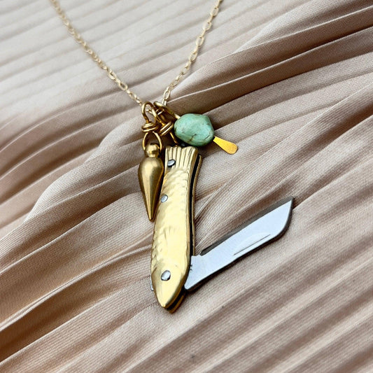 feeesh knife necklace, fish knife pendant, mini knife necklace, pocket knife necklace for women, functional fish knife jewelry, turquoise bullet charm necklace, rogue style necklace, campfire necklace with blade, fishing knife pendant, everyday carry necklace, catch and release jewelry, tiny blade necklace, adventurer pocket knife jewelry, quirky knife necklace, real mini knife pendant