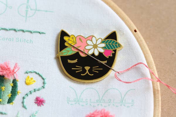 floral cat needleminder, enamel magnetic needle holder, cute cat needle minder, embroidery accessories, cross-stitch supplies, hoop needle magnet, rare earth magnet needleminder, cat-themed sewing tool, stitcher gift idea, magnetic needle keeper