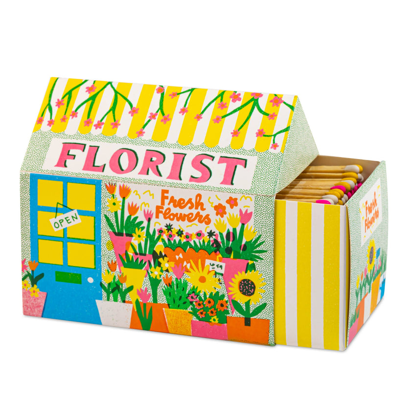 Florist House matchbox, house-shaped safety matches, The Printed Peanut illustration, flower shop matchbox design, floral gift idea, unique house matches, Archivist House Match collection, whimsical illustrated matchbox, botanical matchbox art, UK-made safety matches, flower lover gifts, colorful matchbox for candle lovers, Rogue & Rye curated gifts, artisan matchbox design.