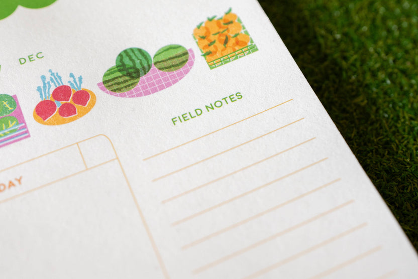 Colorful seasonal produce illustrations on the Freshly Planned weekly planner