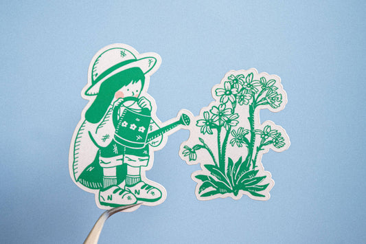 Gardener vinyl sticker showing a person tending flowers with a watering can