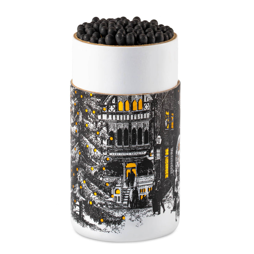Starry Night match cylinder, Chase & Wonder artwork, large holiday match tube, Christmas town square illustration, luxury safety matches, gold foil winter design, festive mantel décor, UK-made match cylinder, Christmas Eve artwork, elegant fireplace matches, collectible holiday home accessories, Archivist Christmas collection, Rogue & Rye curated gifts, cozy seasonal décor.