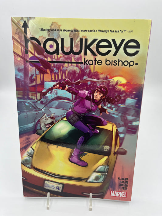 Cover of Hawkeye: Kate Bishop featuring Kate Bishop in her purple Hawkeye costume standing atop a yellow car with bow drawn in a busy city street.