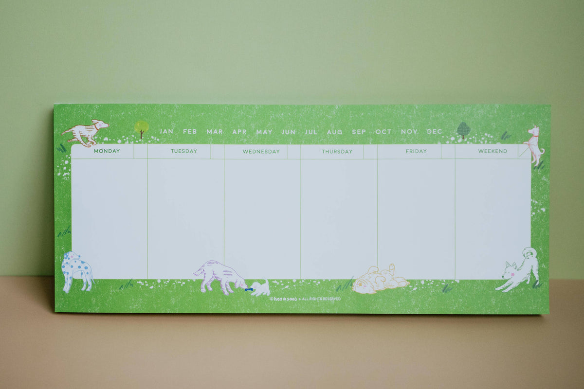 Dog Days undated weekly planner with illustrated dogs on a green border