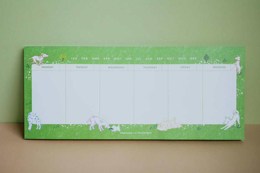 Dog Days undated weekly planner with illustrated dogs on a green border