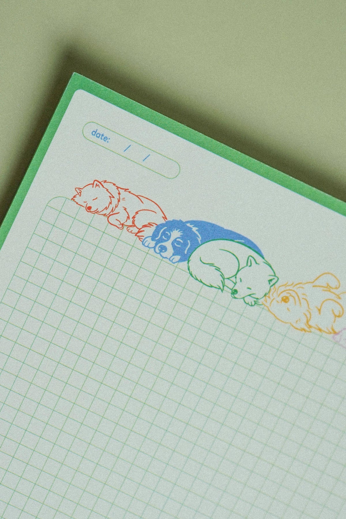 Ruff Drafts grid notepad with colorful sleeping dogs illustrated across the top