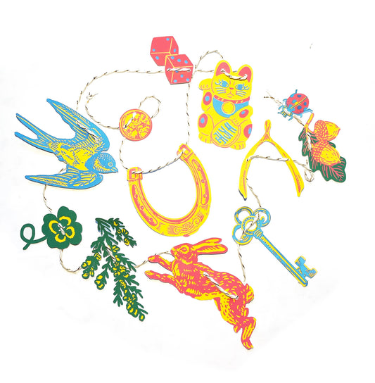 Hissing Mink Good Luck mini paper garland featuring symbols of luck from around the world in a whimsical decorative banner