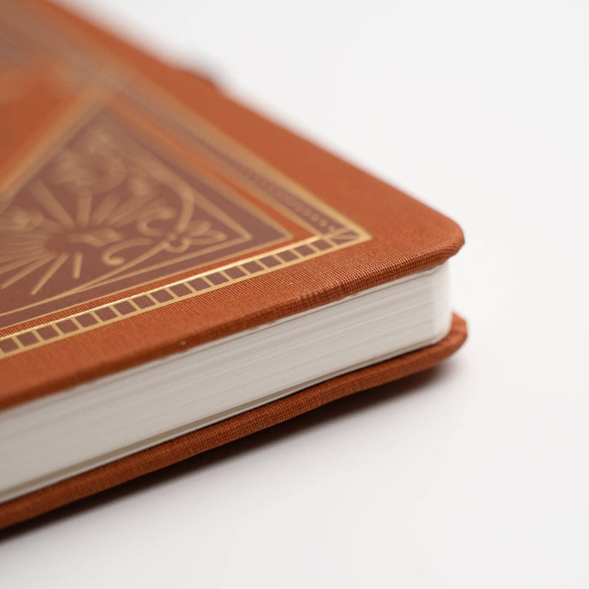Close-up of gold foil detailing on Keeper of Bees rust journal cover