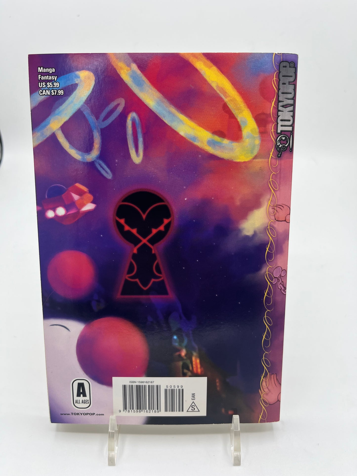 Back cover of Kingdom Hearts Volume 2 featuring a stylized keyhole emblem against a colorful cosmic background from the manga adaptation by Shiro Amano.