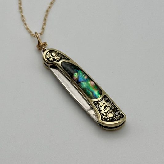 lennox necklace knife, mini knife necklace gold, abalone pocket knife jewelry, stealthy knife pendant, gold filled knife necklace, functional knife jewelry, filigree knife necklace, vintage inspired utility necklace, pocket knife necklace for women, adventurer jewelry, abalone shell pendant knife, necklace with hidden blade, fashionable self defense necklace, secret blade necklace, gold mini knife pendant