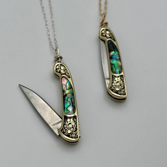 lennox necklace knife, mini knife necklace gold, abalone pocket knife jewelry, stealthy knife pendant, gold filled knife necklace, functional knife jewelry, filigree knife necklace, vintage inspired utility necklace, pocket knife necklace for women, adventurer jewelry, abalone shell pendant knife, necklace with hidden blade, fashionable self defense necklace, secret blade necklace, gold mini knife pendant