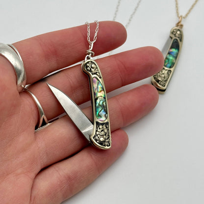 lennox necklace knife, mini knife necklace gold, abalone pocket knife jewelry, stealthy knife pendant, gold filled knife necklace, functional knife jewelry, filigree knife necklace, vintage inspired utility necklace, pocket knife necklace for women, adventurer jewelry, abalone shell pendant knife, necklace with hidden blade, fashionable self defense necklace, secret blade necklace, gold mini knife pendant