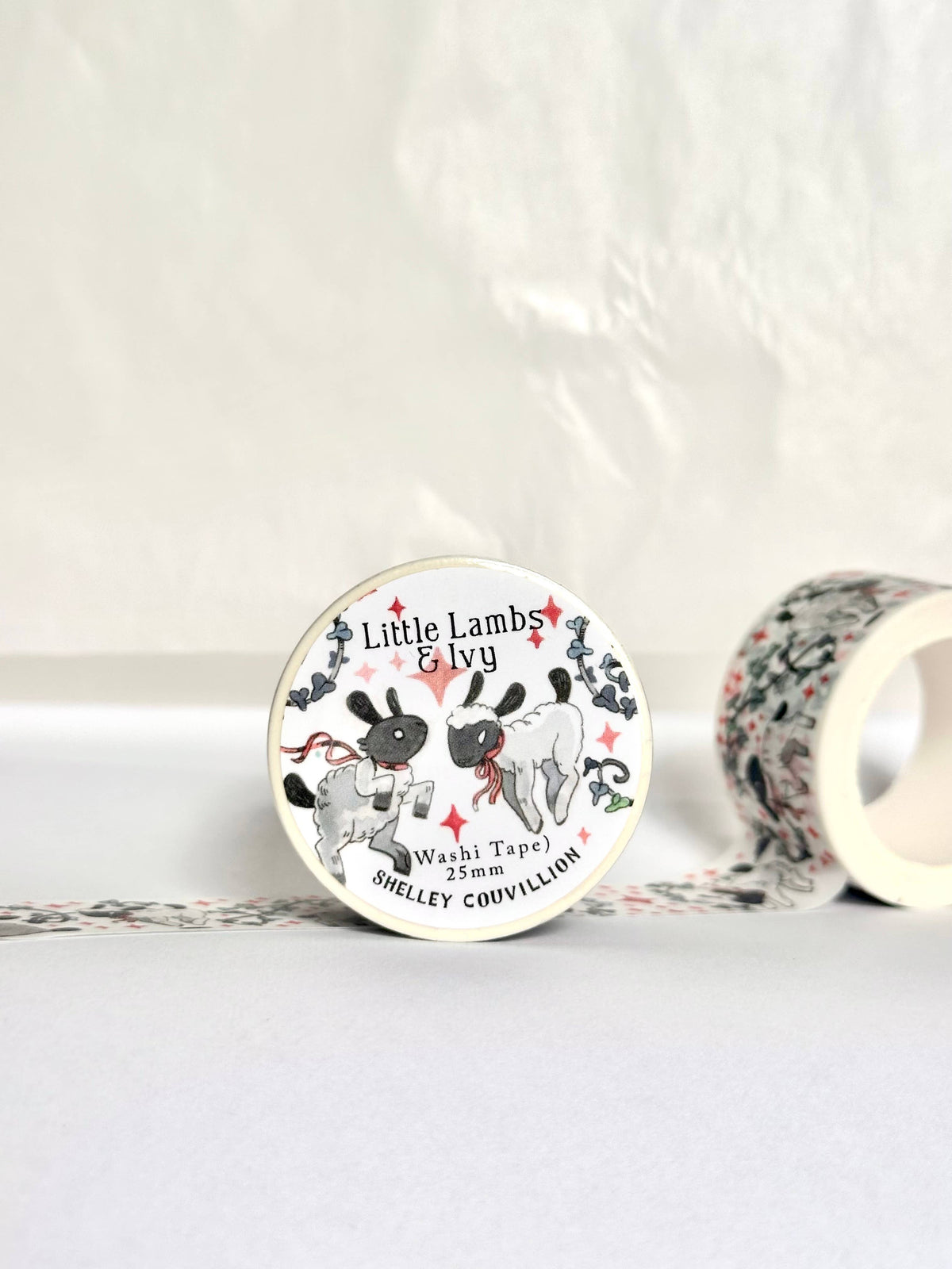 Washi tape with illustrated lambs, red ribbons, and winding ivy