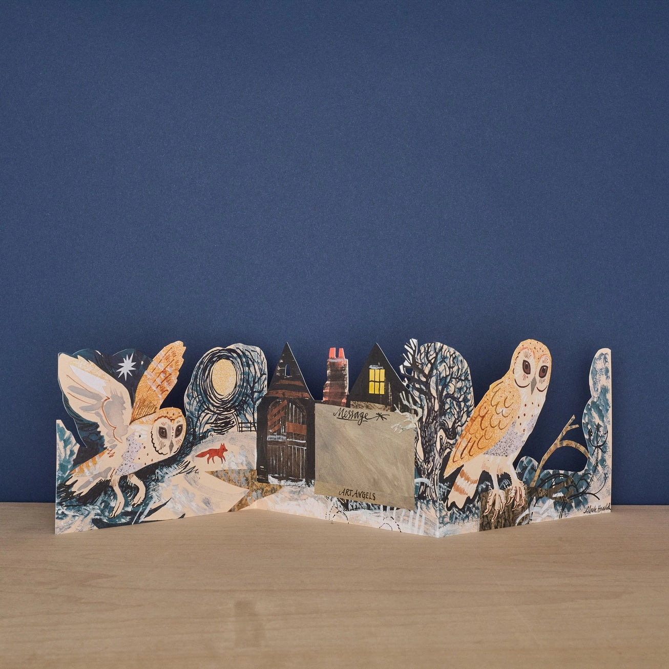 Reverse side of the Mark Hearld Silent Flight accordion greeting card with woodland artwork and blank writing panel.