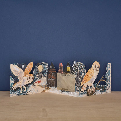Reverse side of the Mark Hearld Silent Flight accordion greeting card with woodland artwork and blank writing panel.