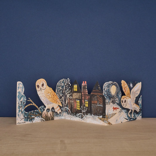 Mark Hearld Silent Flight accordion greeting card with illustrated owls and woodland houses in a winter scene.
