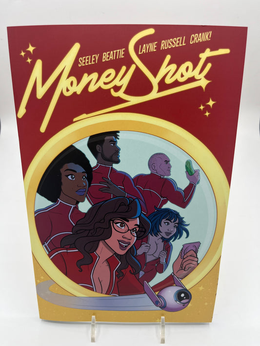 Cover of Money Shot Volume 3 featuring the crew of interplanetary researchers in red uniforms illustrated in a colorful science fiction comic style.