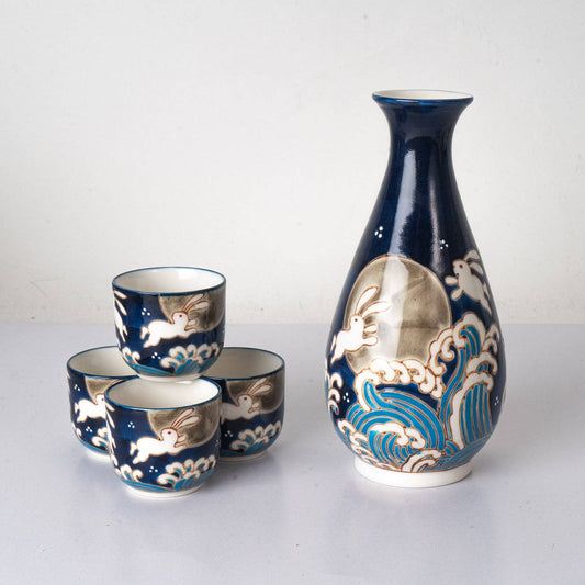 moon rabbit sake set, porcelain sake bottle and cups, Japanese-inspired drinkware, Urban Tokyo sake set, moon rabbit folklore design, celestial sake gift set, 10 oz sake bottle with cups, porcelain glaze drinkware, Rogue & Rye home and kitchen collection, housewarming gift ideas, unique sake set gift, cultural drinkware set, moon rabbit kitchenware.