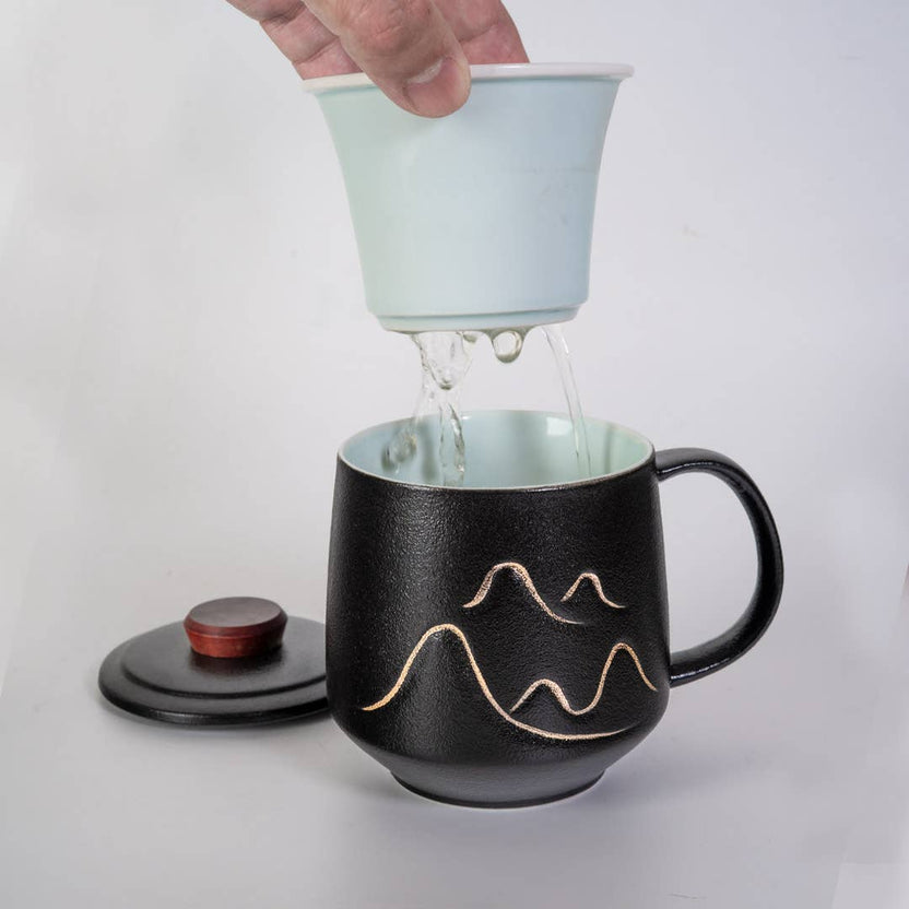 mountain tea mug, porcelain tea mug with infuser, Urban Tokyo tea mug, Japanese-style tea mug, loose-leaf tea brewing mug, black porcelain infuser mug, lidded tea mug, modern minimalist tea cup, gift for tea lovers, mountain design drinkware, elegant kitchen gifts, ceramic tea mug with strainer, Rogue & Rye cozy rituals collection, everyday tea essentials, Japanese home goods aesthetic.