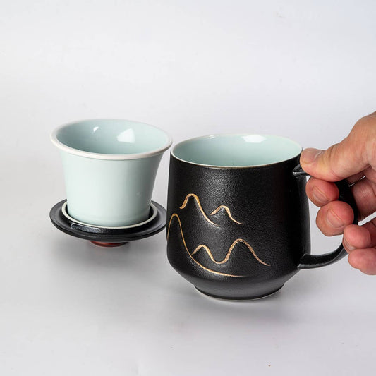 mountain tea mug, porcelain tea mug with infuser, Urban Tokyo tea mug, Japanese-style tea mug, loose-leaf tea brewing mug, black porcelain infuser mug, lidded tea mug, modern minimalist tea cup, gift for tea lovers, mountain design drinkware, elegant kitchen gifts, ceramic tea mug with strainer, Rogue & Rye cozy rituals collection, everyday tea essentials, Japanese home goods aesthetic.