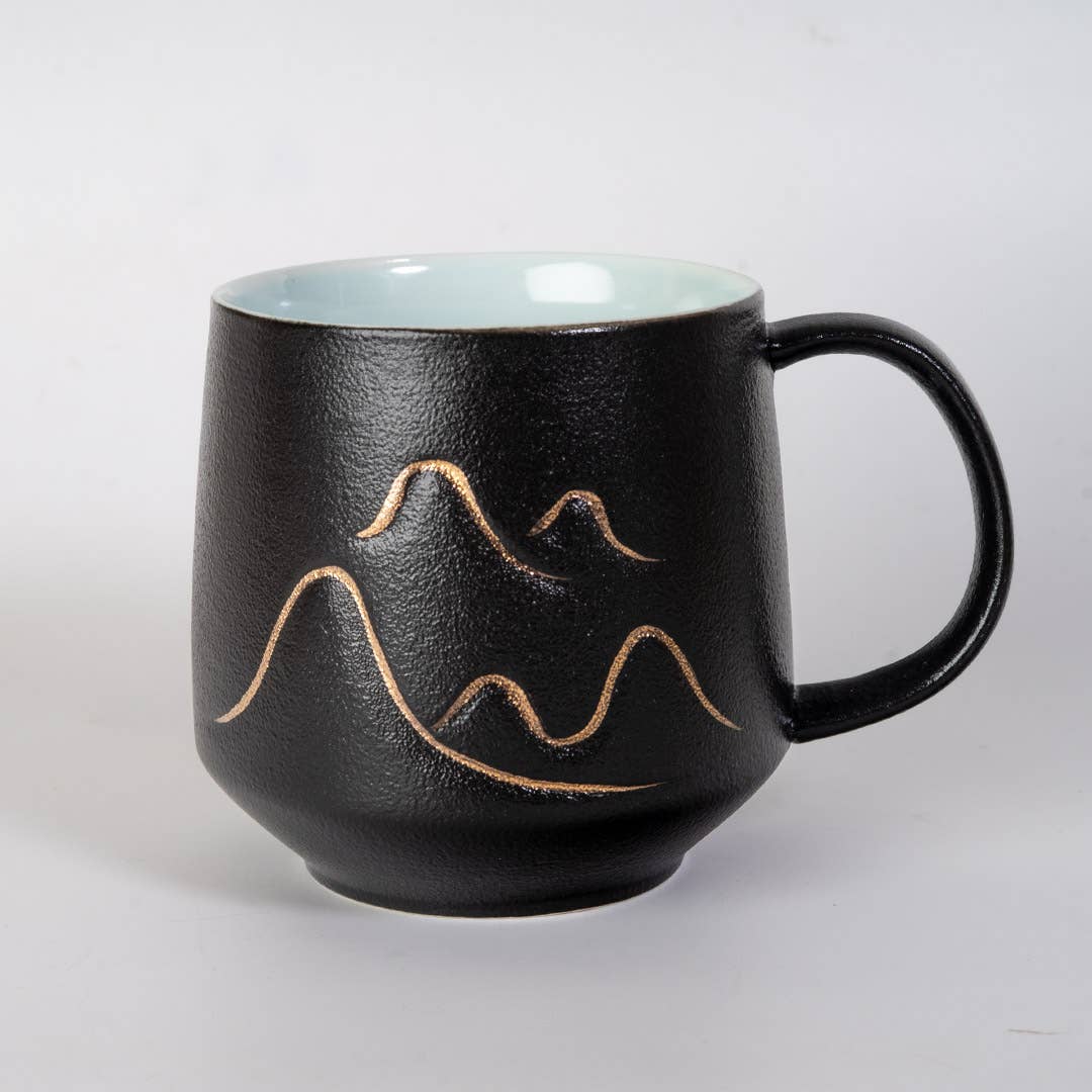 mountain tea mug, porcelain tea mug with infuser, Urban Tokyo tea mug, Japanese-style tea mug, loose-leaf tea brewing mug, black porcelain infuser mug, lidded tea mug, modern minimalist tea cup, gift for tea lovers, mountain design drinkware, elegant kitchen gifts, ceramic tea mug with strainer, Rogue & Rye cozy rituals collection, everyday tea essentials, Japanese home goods aesthetic.