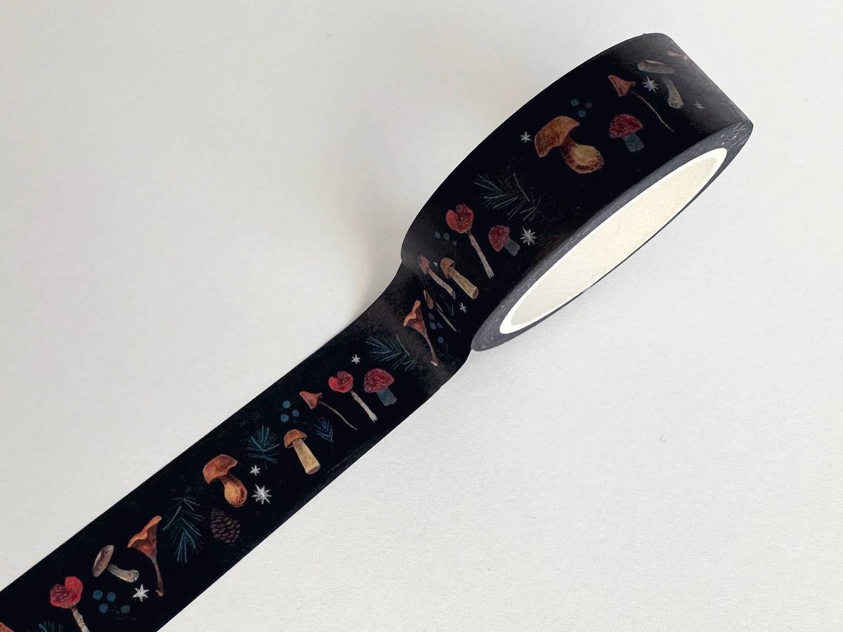 Unrolled dark washi tape with illustrated autumn mushrooms and woodland plants