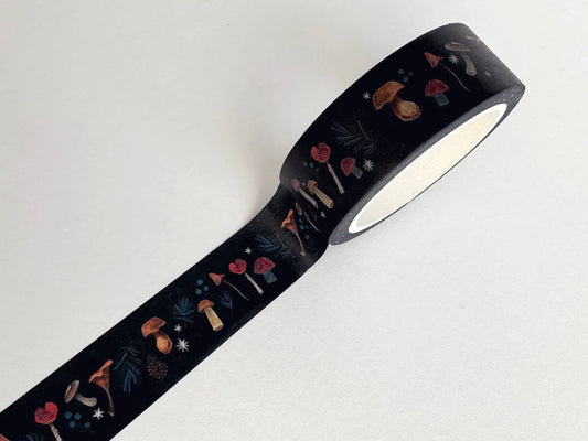 Unrolled dark washi tape with illustrated autumn mushrooms and woodland plants