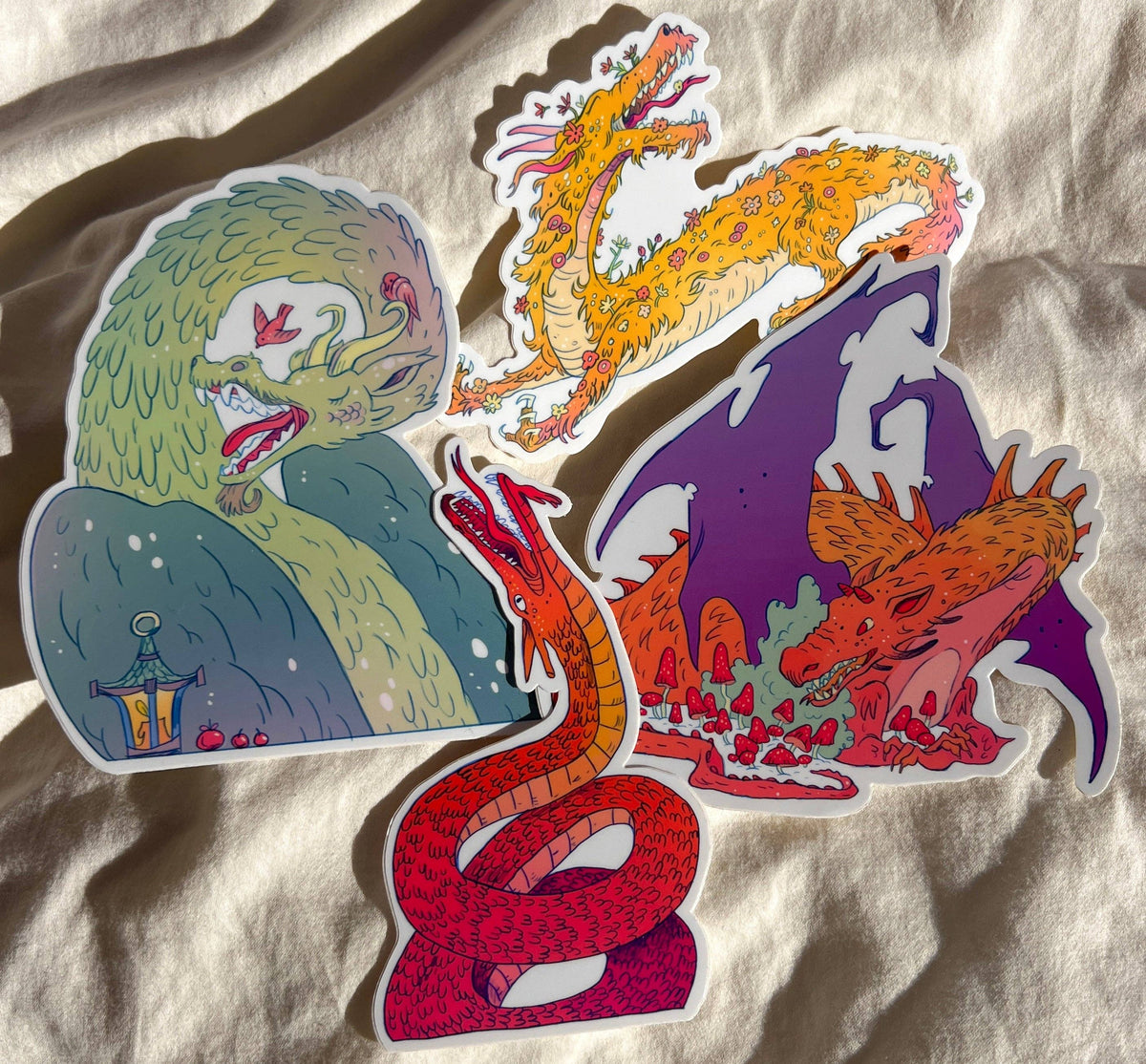 Set of four large colorful dragon stickers illustrated by Natalie Andrewson