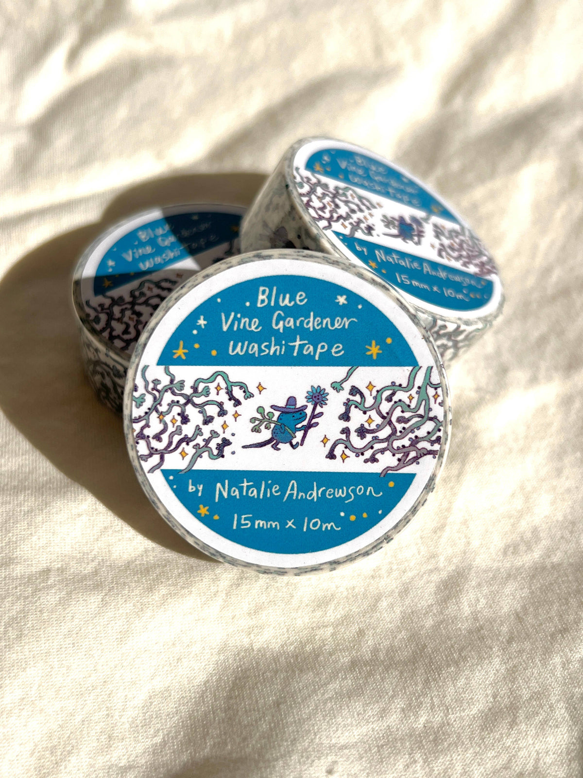 Stack of colorful Natalie Andrewson washi tapes with illustrated design tags