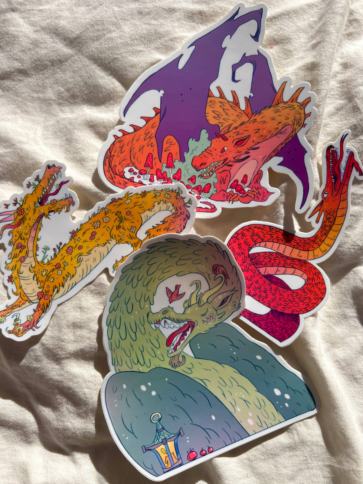 Large illustrated dragon vinyl stickers by Natalie Andrewson shown together
