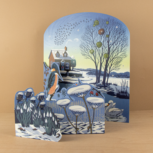 Niki Bowers Winter Riverside Advent Calendar featuring a snowy riverside scene with a kingfisher, swans, and 24 opening windows.
