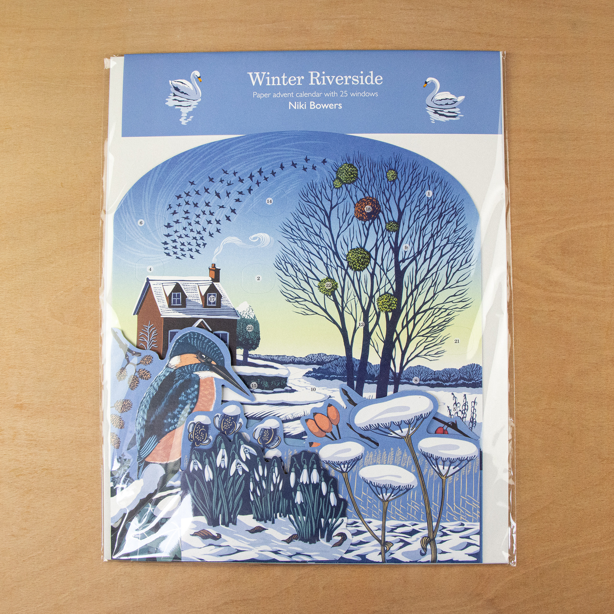 Niki Bowers Winter Riverside Advent Calendar packaged in a protective clear sleeve with branded header card.