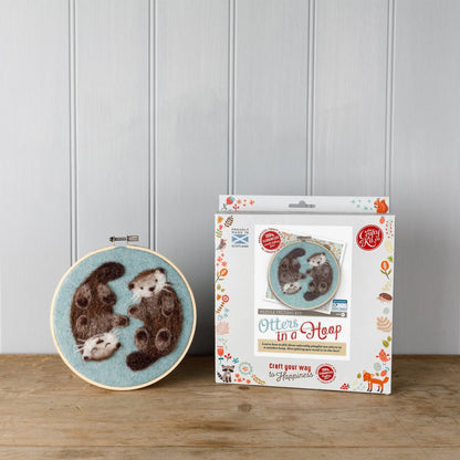 otters needle felting kit, otters in a hoop craft kit, painting with wool otters, beginner needle felting project, diy wool animal art, corriedale wool felting kit, 2d felting kit with hoop, otter wall art craft kit, crafty kit company otters, wool felt otter kit, felt animal couple project, scottish felting kits, embroidery hoop felt animals, felt otter gift idea, eco-friendly craft kit