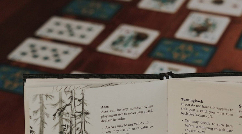 pnw card games book, pacific northwest inspired games, megan wyreweden art, thomas cardwell game designer, nature themed card games, foraging card games, orca salmon mushroom games, coastal forest games, pacific northwest game night, illustrated card game book, camping games with deck of cards, solo and group card games, pnw camping activities, original card games book, pacific northwest gifts, travel