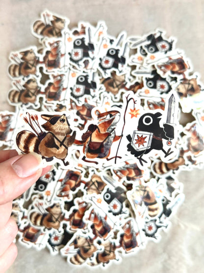 adventuring party animal sticker, raccoon and crow vinyl sticker, dnd animal party sticker, fantasy animal adventurers, chipmunk wizard sticker, rogue raccoon sticker, crow with sword art, waterproof rpg sticker, vinyl dnd character sticker, cute animal adventurers decal