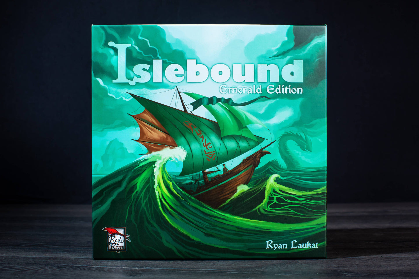 Islebound Emerald Edition, Islebound board game, Red Raven Games Islebound, World of Arzium board game, Ryan Laukat game, sea faring strategy board game, nautical fantasy board game, archipelago board game, pirates and sea monsters board game, trade build invade board game, island town strategy game, capital city building board game, crew hiring board game, emerald resource board game, revised building deck Emerald Edition, 2 to 4 player strategy game, 30 minute strategy board game, fantasy adventure strate