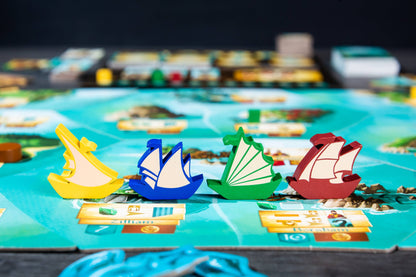 Islebound Emerald Edition, Islebound board game, Red Raven Games Islebound, World of Arzium board game, Ryan Laukat game, sea faring strategy board game, nautical fantasy board game, archipelago board game, pirates and sea monsters board game, trade build invade board game, island town strategy game, capital city building board game, crew hiring board game, emerald resource board game, revised building deck Emerald Edition, 2 to 4 player strategy game, 30 minute strategy board game, fantasy adventure strate