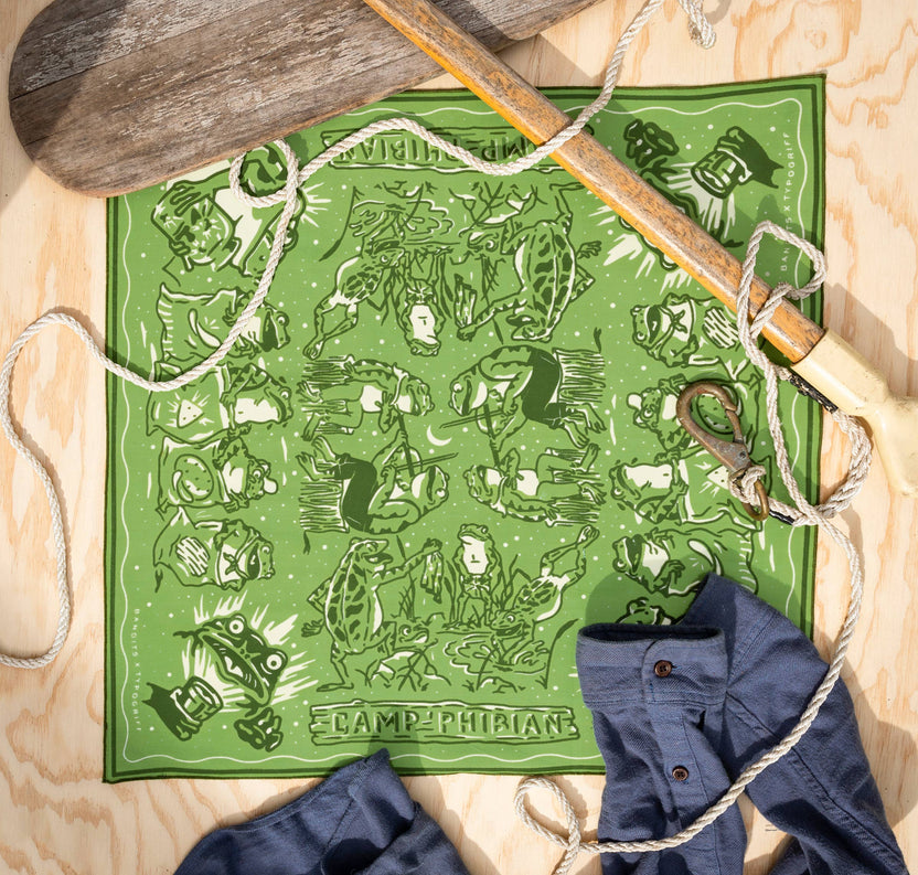 The Camp Phibian Bandana by Bandits Bandanas features original artwork by Lauren Griffin and is crafted from GOTS-certified, Fair Trade Certified organic cotton. Soft, breathable, and easy to style, this 21" × 21" bandana is perfect for everyday wear—tied at the neck, in the hair, or on a favorite bag. Each purchase gives back, with 10% of proceeds supporting The Brigid Alliance, making it a meaningful, artist-driven accessory designed to be lived in.