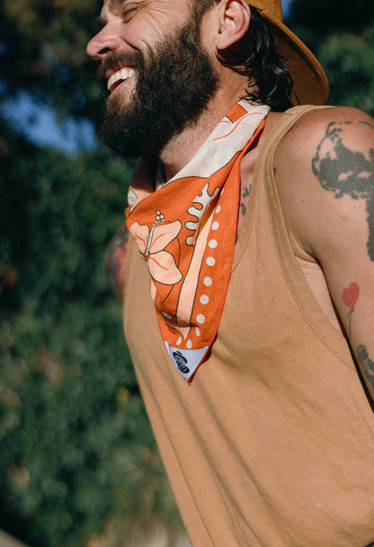 The Na’Pali Coast Bandana by Bandits Bandanas features original artwork by Lisa McCormick, inspired by the iconic coastline of Kaua‘i. Made from 100% GOTS-certified organic cotton and Fair Trade Certified, this ultra-soft bandana is a versatile accessory for hair, neck, bag styling, and everyday wear. Plus, 10% of proceeds support Love One International, making it a thoughtful, artist-driven gift with real impact.